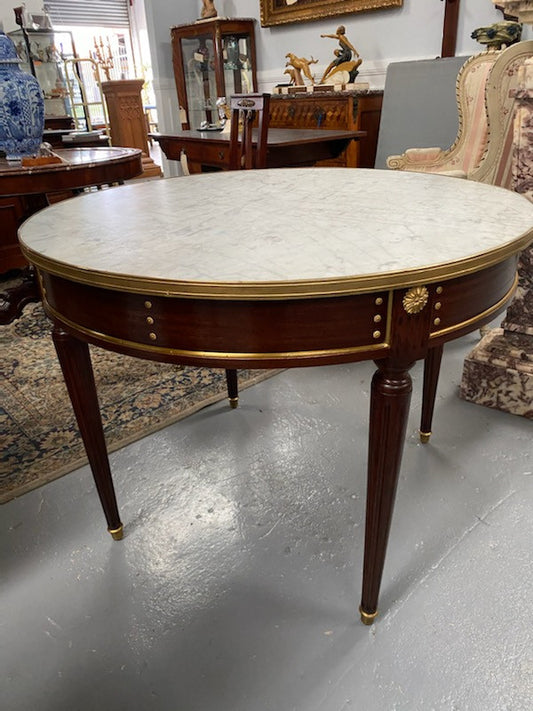 Stunning Antique French Louis XVI Style Mahogany & marble top round table. It has beautiful ormolu mounts and is in restored condition. Could be used as a dining table or as a center table.