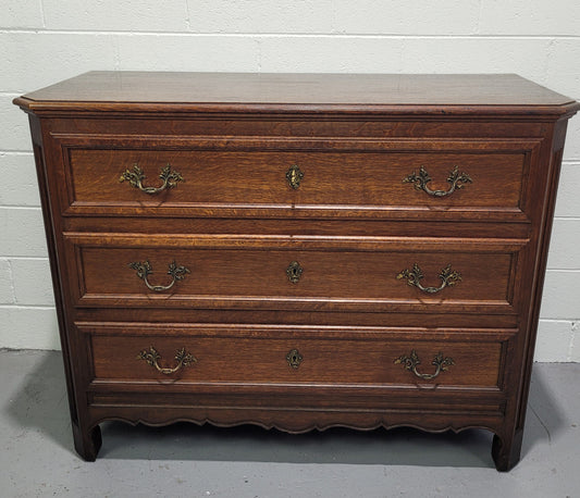 Solid Oak French 19th century three drawer commode, with decorative handles. In good original detailed condition.