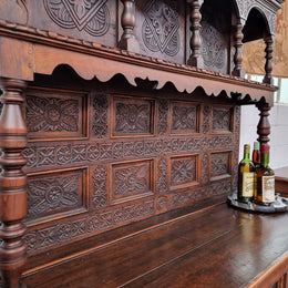 Impressively carved 18th Century English Oak kitchen dresser in 17th Century Jacobean style. It is in good original detailed condition and has been sourced from France.