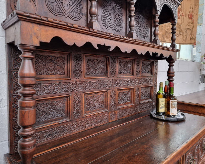Impressively carved 18th Century English Oak kitchen dresser in 17th Century Jacobean style. It is in good original detailed condition and has been sourced from France.