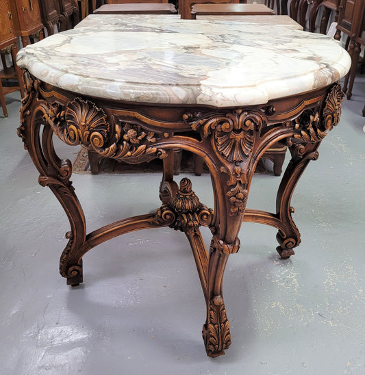 French Walnut Louis XV style round marble top centre table. It has amazing eye-catching marble, ornate detailed carvings and a beautifully carved undercarriage. In good original detailed condition.