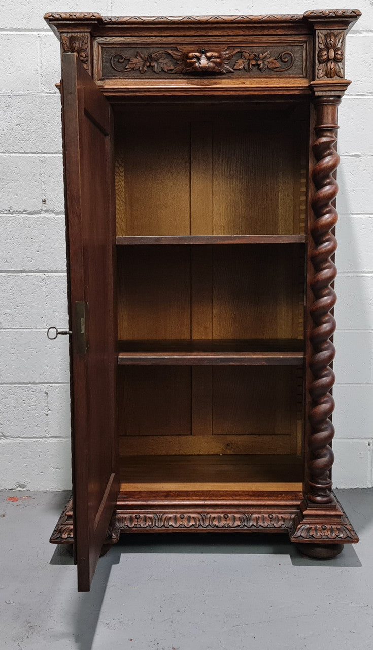 French Henry 2nd Oak Side Cabinet of pleasing narrow proportions.  Carving on the cup board and drawer fronts with barley twist columns.