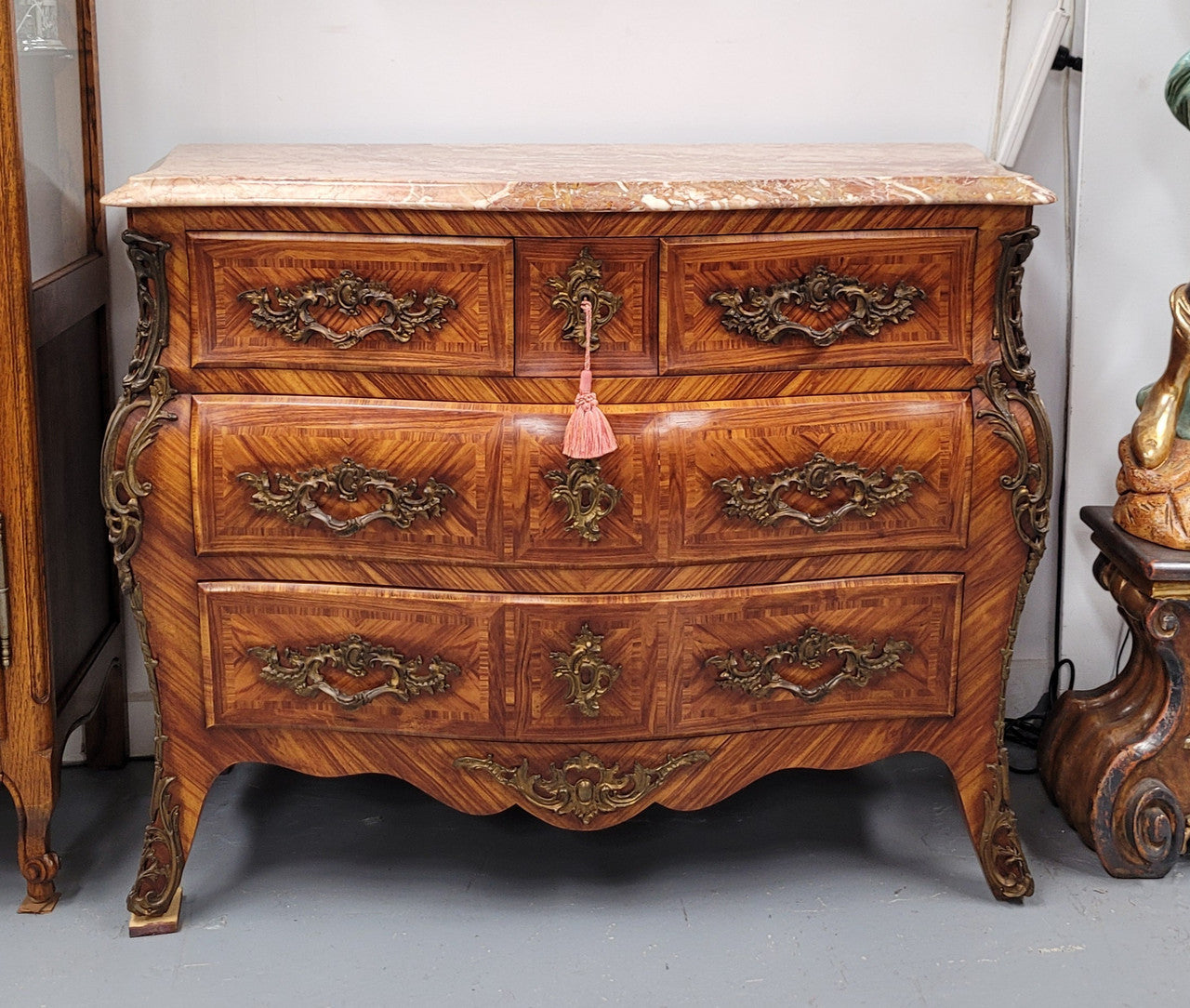 Beautiful French Louis XV style Kingwood inlaid marble top four drawer commode. It has decorative mounts and has been sourced from France. It is in good original detailed condition.