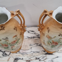 Decorative Pair of Art Nouveau Vases decorated with hand finished roses in muted tones. Gilt highlights. Impressed numbers to base. In good original condition, please view photos as they help form part of the description.