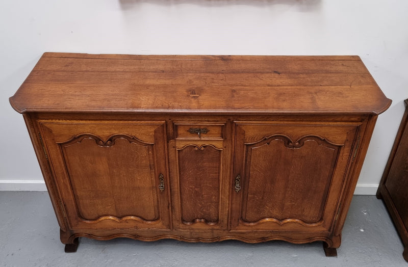 Amazing French Oak early 19th Century two door sideboard with one drawer and two fixed shelves. Sourced from France and in good original detailed condition.