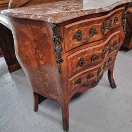 Antique French Louis XV style compact three drawer marble top commode with marquetry inlay and ormolu mounts. Sourced from France and in good original detailed condition.