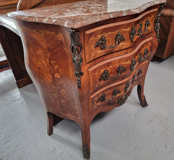 Antique French Louis XV style compact three drawer marble top commode with marquetry inlay and ormolu mounts. Sourced from France and in good original detailed condition.