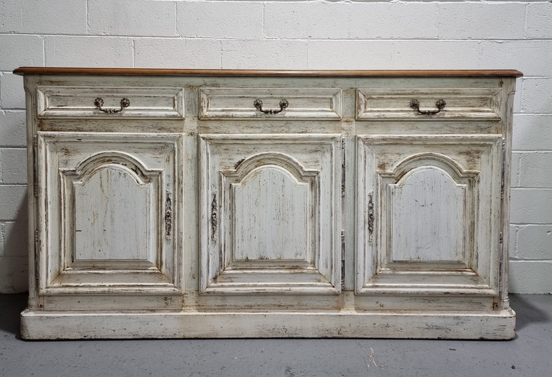 19th Century French painted three door oak buffet. Plenty of storage space with three drawers and doors. In good original condition.