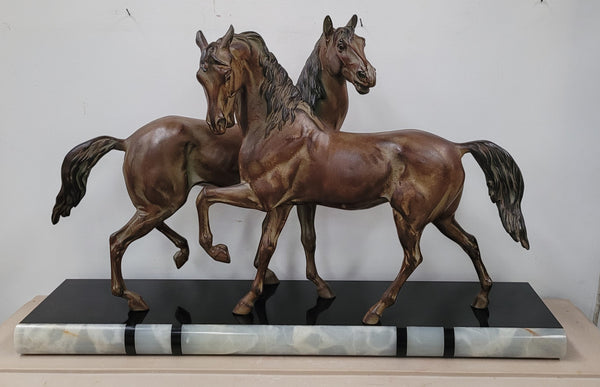Art Deco patinated bronze French spelter horses on a stunning marble base. It is in good original detailed condition.