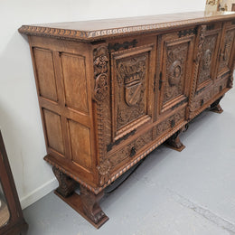 Large French Oak Renaissance style four door sideboard/buffet. Great decorative item with amazing carvings and stunning iron work on base. It is in good original detailed condition. Can pull apart completely making it easier to move.