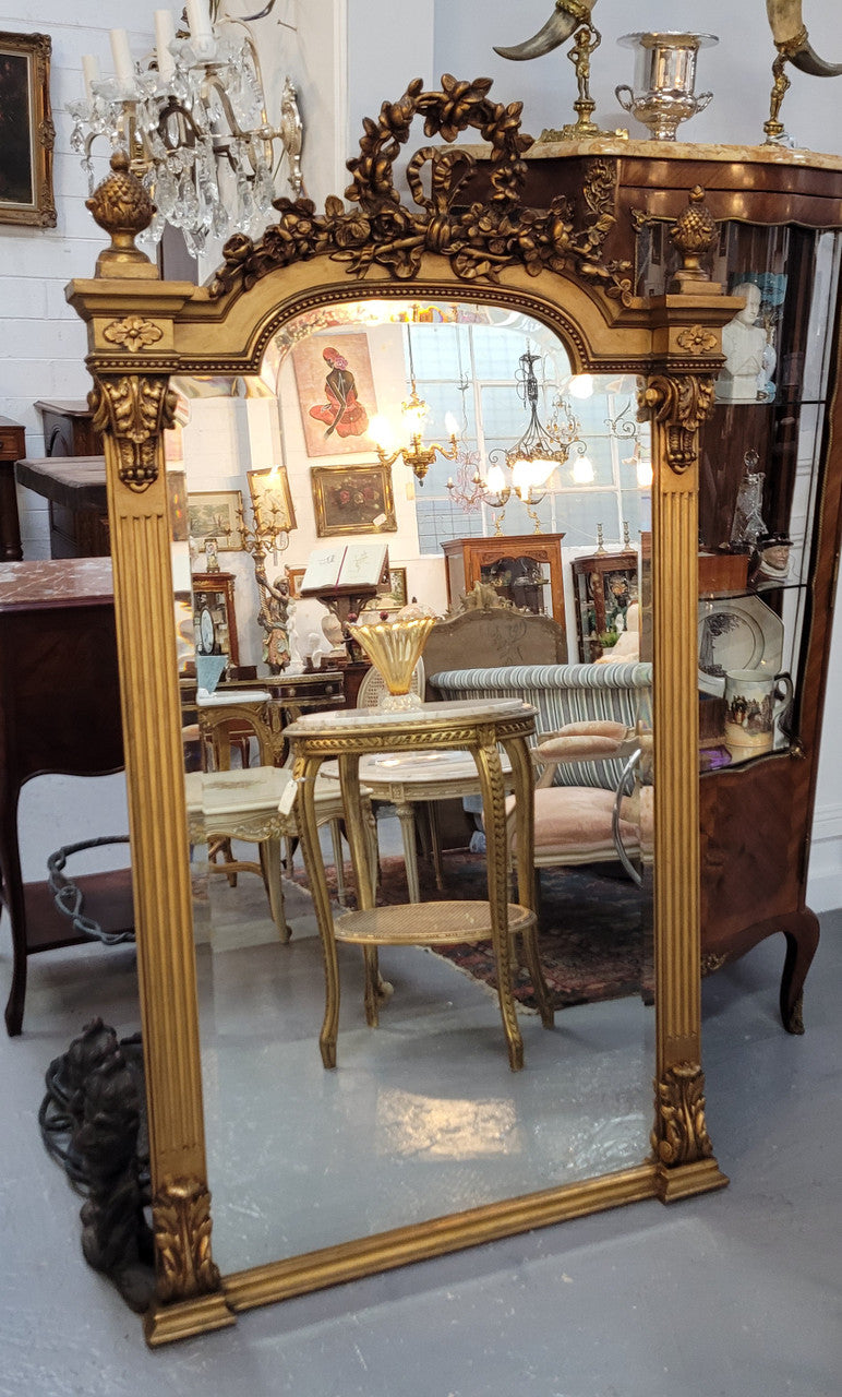 French Louis XVI style Napoleon III (1870’s) gilt mantle mirror. Beautifully carved and decorated with original bevelled mirror showing signs of age. It is in good original detailed condition and has been sourced from France.