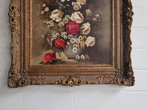 Attractive French floral oil on canvas - signed. Mounted in a stunning patterned gilded frame. It is in good original detailed condition.