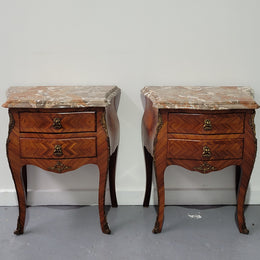 Pair of Louis XV commode style two drawer bedsides with beautiful marble tops and decorative mounts. They are a rare size and are in good, detailed condition.