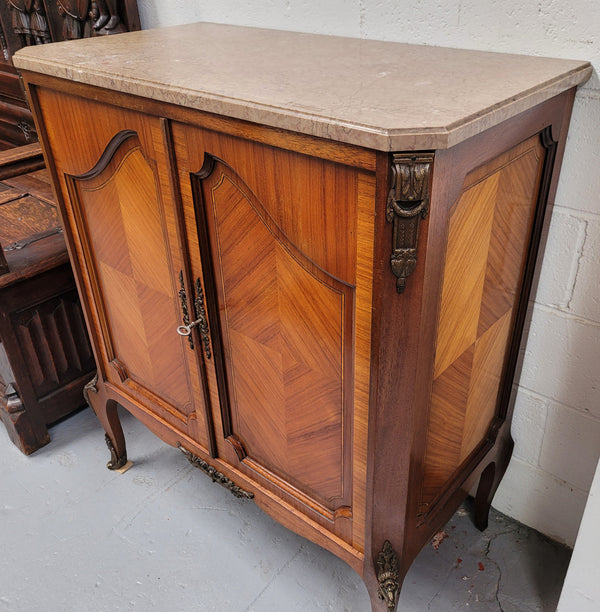 Stunning compact Louis 15th style two door walnut cabinet with ormolu trim and marble top. It is in good original condition.