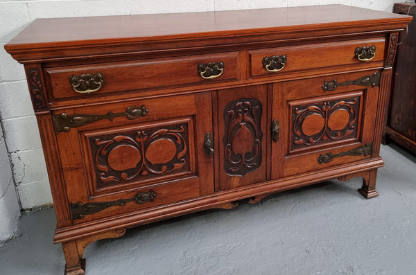 Beautiful decorative Art Nouveau sideboard with lovely handles and beautiful carved detailing. It is in good original detailed condition.