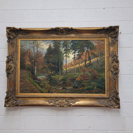 Large signed oil on canvas depicting a river stream in autumn framed in a stunning gilt frame. Sourced from France and is in good original detailed condition.
