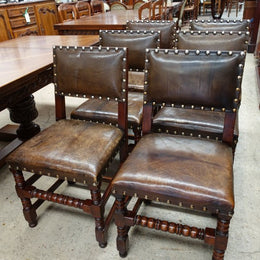 Here we have a fabulous set of six French oak rustic leather dining chairs with two carvers. Chairs are upholstered in brown leather and are very comfortable and solid. Is in very good original condition.