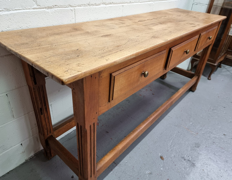 Late 19th Century Cherrywood console table with three drawers. In good used, detailed rustic condition.
