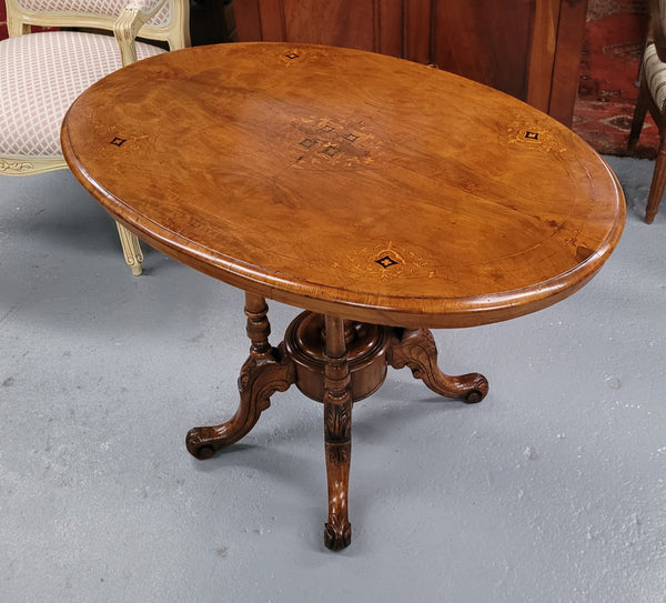 Victorian Walnut oval beautifully inlaid occasional table with bird cage undercarriage. It is in good original detailed condition and it has been sourced locally.