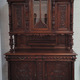 Spectacular French Antique Walnut Renaissance Style buffet with amazing detailed carvings. Plenty of storage space with five cupboards and two large drawers. The three top cupboards open up to two adjustable shelves in each section and the two bottom drawers open up to one large fully adjustable shelve. In good original detailed condition. Circa 1860.