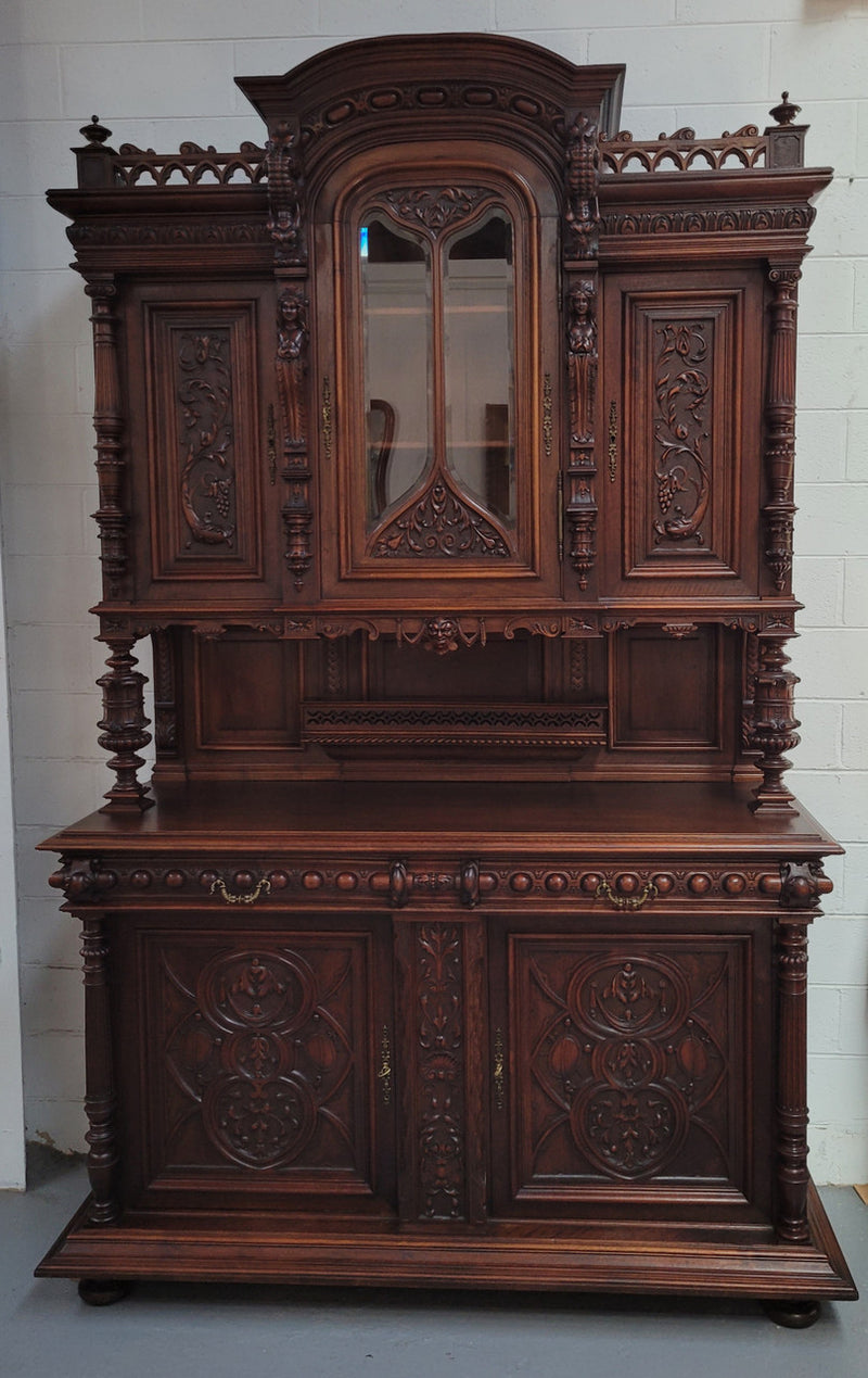 Spectacular French Antique Walnut Renaissance Style buffet with amazing detailed carvings. Plenty of storage space with five cupboards and two large drawers. The three top cupboards open up to two adjustable shelves in each section and the two bottom drawers open up to one large fully adjustable shelve. In good original detailed condition. Circa 1860.