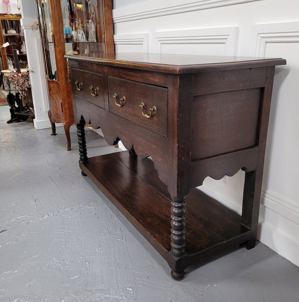 Rare size 19th Century English oak dresser base. It has two good size drawers and amazing patina. It has been sourced from France and in good original detailed condition.