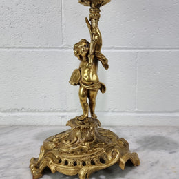 A pretty 19th Century French gilt bronze candelabra featuring a cherub. In good condition. Circa 1880.