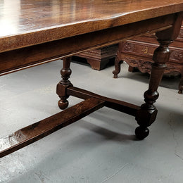 Rustic French Oak stretcher based farmhouse dining table that comfortably seats 6-8 people. It has been sourced from France and is in good original condition.