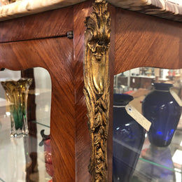 A Louis XV style Kingwood vitrine with marble top. It has beautifully floral inlay with ormolu mounts.