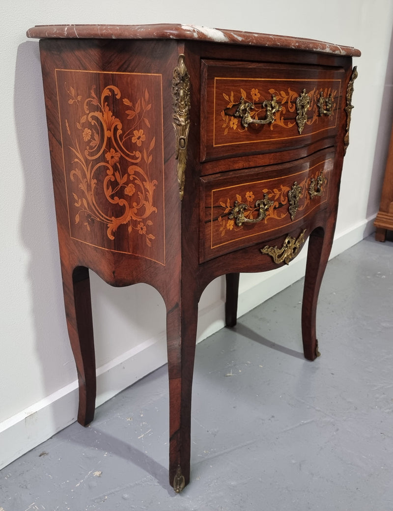 A stunning French petite two drawer inlaid Rosewood commode. In good original detailed condition.