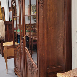 Substantial French Oak Louis 15th Style large two door bookcase. Adjustable shelves and very decorative carving. In good original detailed condition.