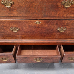 Early 19th Century English Oak chest on stand. It has been sourced in France and has plenty of storage space with eight drawers. In good original detailed condition.