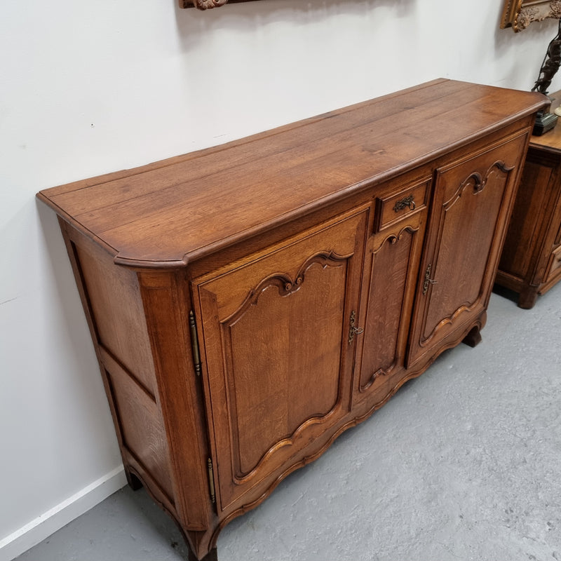 Amazing French Oak early 19th Century two door sideboard with one drawer and two fixed shelves. Sourced from France and in good original detailed condition.