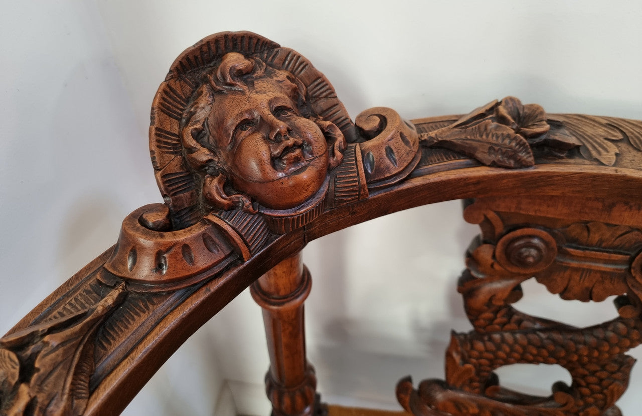 Beautifully carved French Walnut corner chair with upholstered seat. In good original detailed condition.