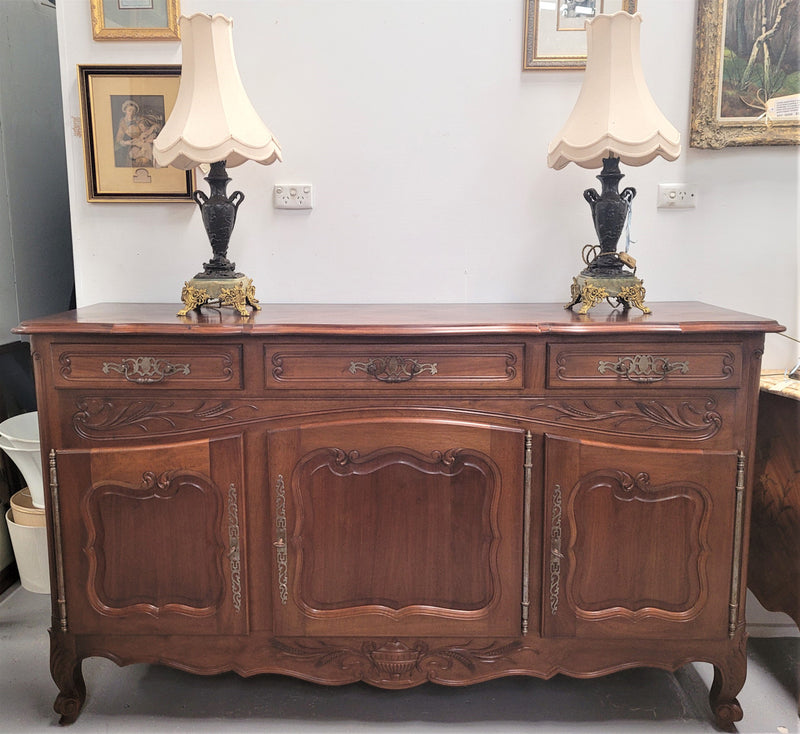 Louis XV style Walnut sideboard with three drawers and three doors. In good original detailed condition.