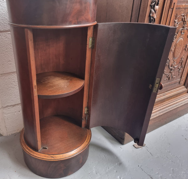 Unusual Empire flame Mahogany cylindrical marble topped bedside/pedestal. Would make an ideal pedestal with added storage inside or could be used as a bedside. Sourced from France and is in good original detailed condition.