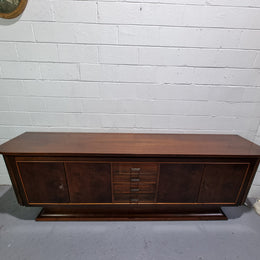 Amazing French Walnut Art deco four door buffet. The doors either side open to a fixed shelf and plenty of added storage with four drawers. In good original detailed condition.