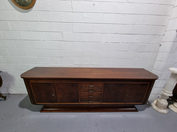 Amazing French Walnut Art deco four door buffet. The doors either side open to a fixed shelf and plenty of added storage with four drawers. In good original detailed condition.