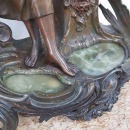 An elegant French Art Nouveau figural clock, with onyx marble depicting water and constructed from spelter. The clock is 61cm high and is in good original condition and in working order.