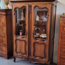 French Walnut Louis XV Style two half glass, door bookcase with three adjustable shelves. Sourced from France and in good original detailed condition.