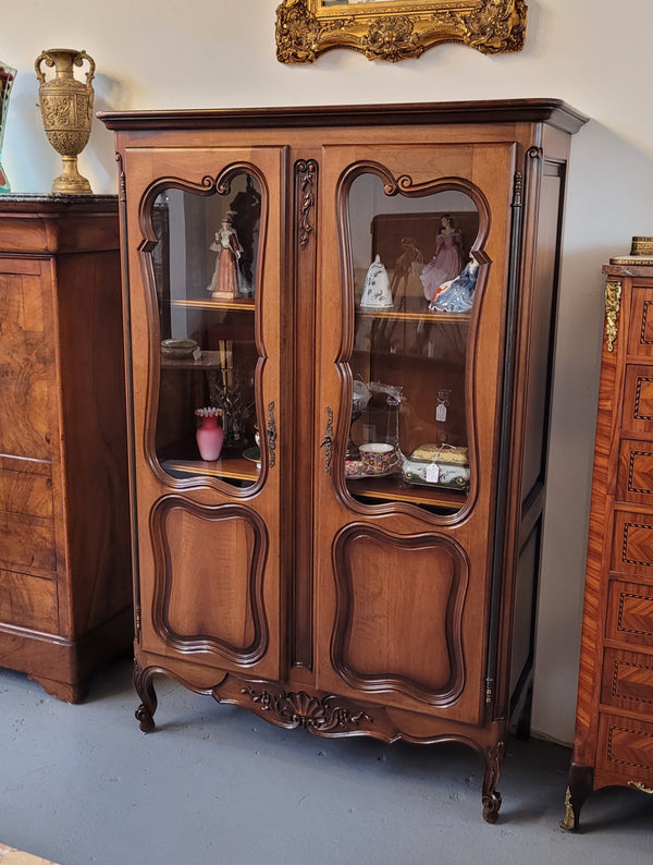 French Walnut Louis XV Style two half glass, door bookcase with three adjustable shelves. Sourced from France and in good original detailed condition.