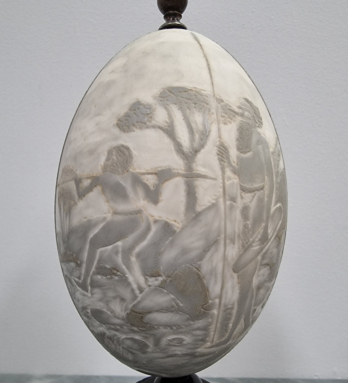 Superbly carved Emu egg on a emu metal and ebony base. It depicts an Aboriginal hunting scene and dreaming's. It is in good original condition, please view photos as they help form part of the description.