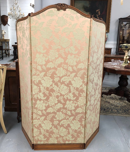 An antique French Walnut louis XVI style 3 fold screen/divider. Upholstered with beautiful pink silk brocade fabric. The fabric is in good overall condition with some minor wear and tear which is expected for its age. It has been sourced directly from France. Please view photos as they help to form part of the description and condition.