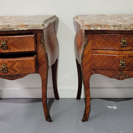 Pair of Louis XV commode style two drawer bedsides with beautiful marble tops and decorative mounts. They are a rare size and are in good, detailed condition.