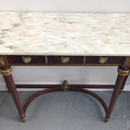 Narrow mahogany Louis XVI style console table with a marble top, ceramic inserts and gilt brass mounts.