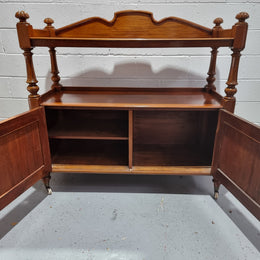 Victorian Mahogany Dumb Waiter with two cupboards, original casters in good detailed condition.