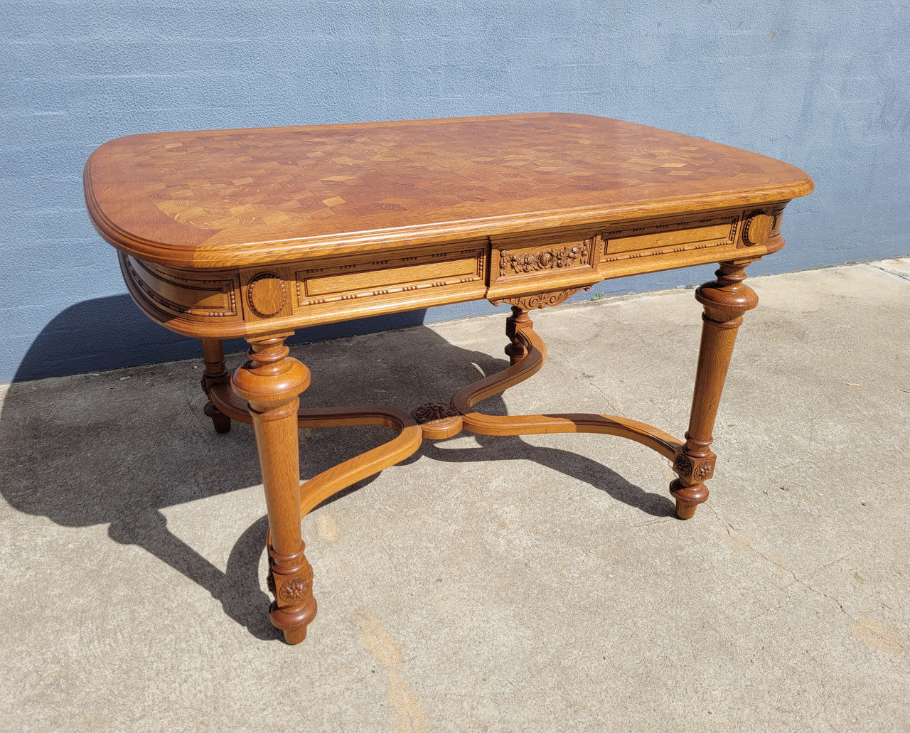 Beautiful carved French Oak dining table with a parquetry top and six matching upholstered chairs. All in good original detailed condition.