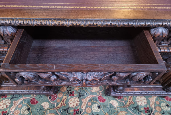 Beautifully carved French Oak early 19th century pedestal desk with 3 drawers, two cupboards and a secret cupboard on the side. There is also a lovely burgundy tooled leather top. In good original detailed condition.