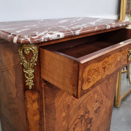 Elegant French transitional style Walnut & Kingwood Salon cabinet. It has beautiful marquetry inlay, a marble top and decorative ormolu mounts. Sourced From France and is in good original detailed condition.