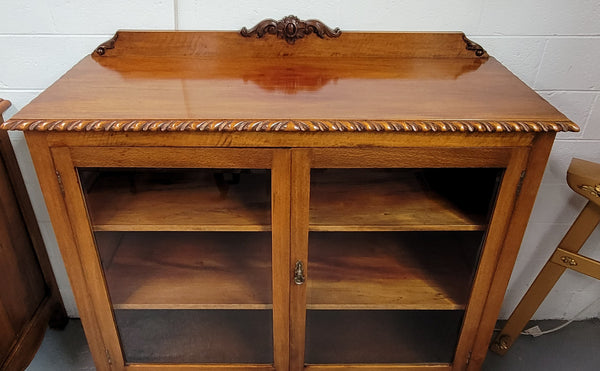 Chippendale style Mahogany two door bookcase. It has bevelled glass doors and two adjustable shelves. It has been sourced locally and is in good original detailed condition.